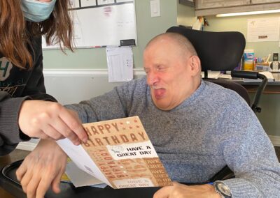 Jim is handed a birthday card by his staff member