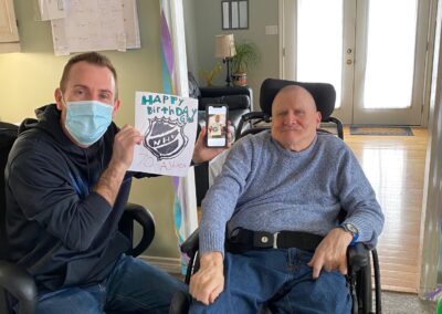 Jim reading a birthday card with his staff member